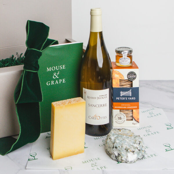 Hamper with a French wine, two cheeses, crackers and honey