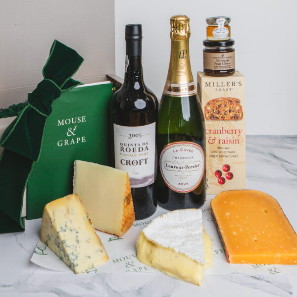 A bottle of port and sparkling wine, four cheeses crackers, fruit cheese and honey