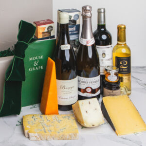 A christmas hamper with four wines, four cheeses, fruit cheese, honey and two boxes of crackers